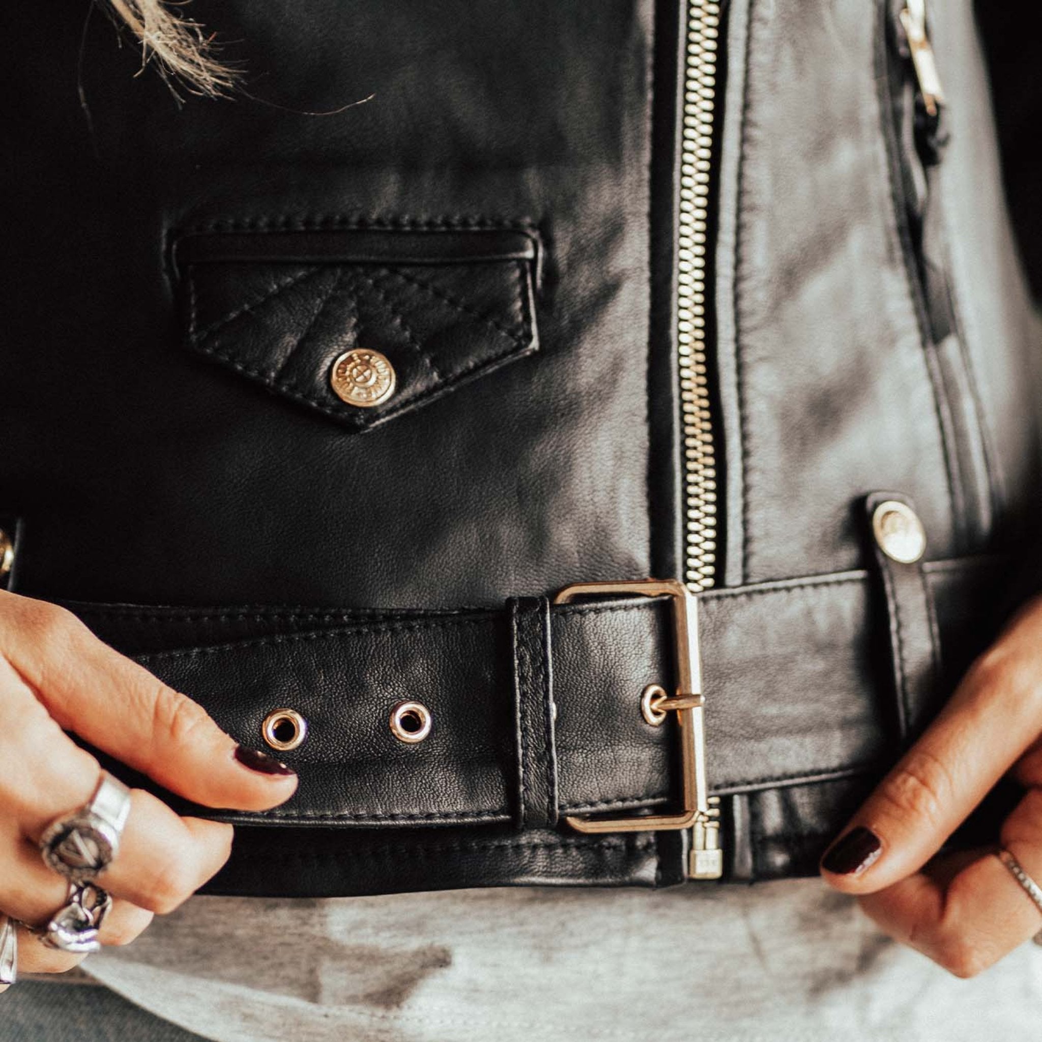 A close up of the belt on the Classic retro black women&#39;s motorcycle jacket from Eudoxie