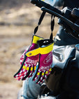 Ride like a Girl pink, black and yellow women's motorcycle gloves from eudoxie hanging on a motorcycle 