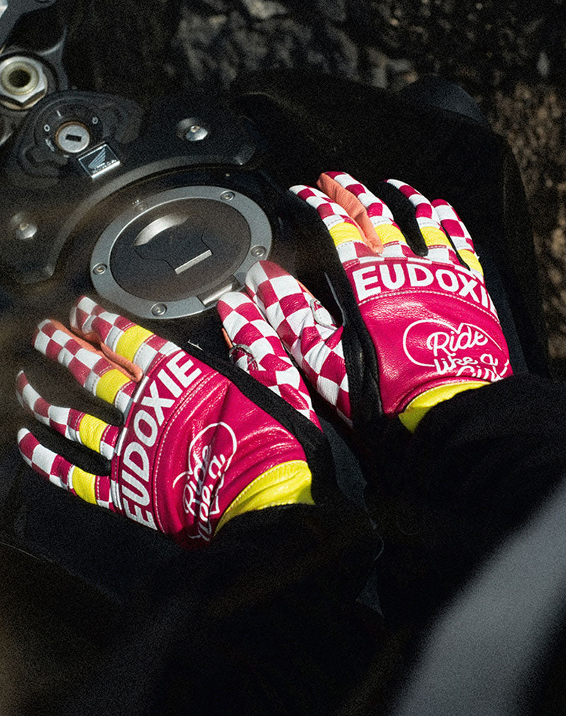 Ride like a Girl pink, black and yellow women&#39;s motorcycle gloves from eudoxie on the motorcycle&#39;s gas tank