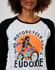 A young woman wearing black & white baseball motorcycle t-shirt with Girl motorcycle label motive from Eudoxie 