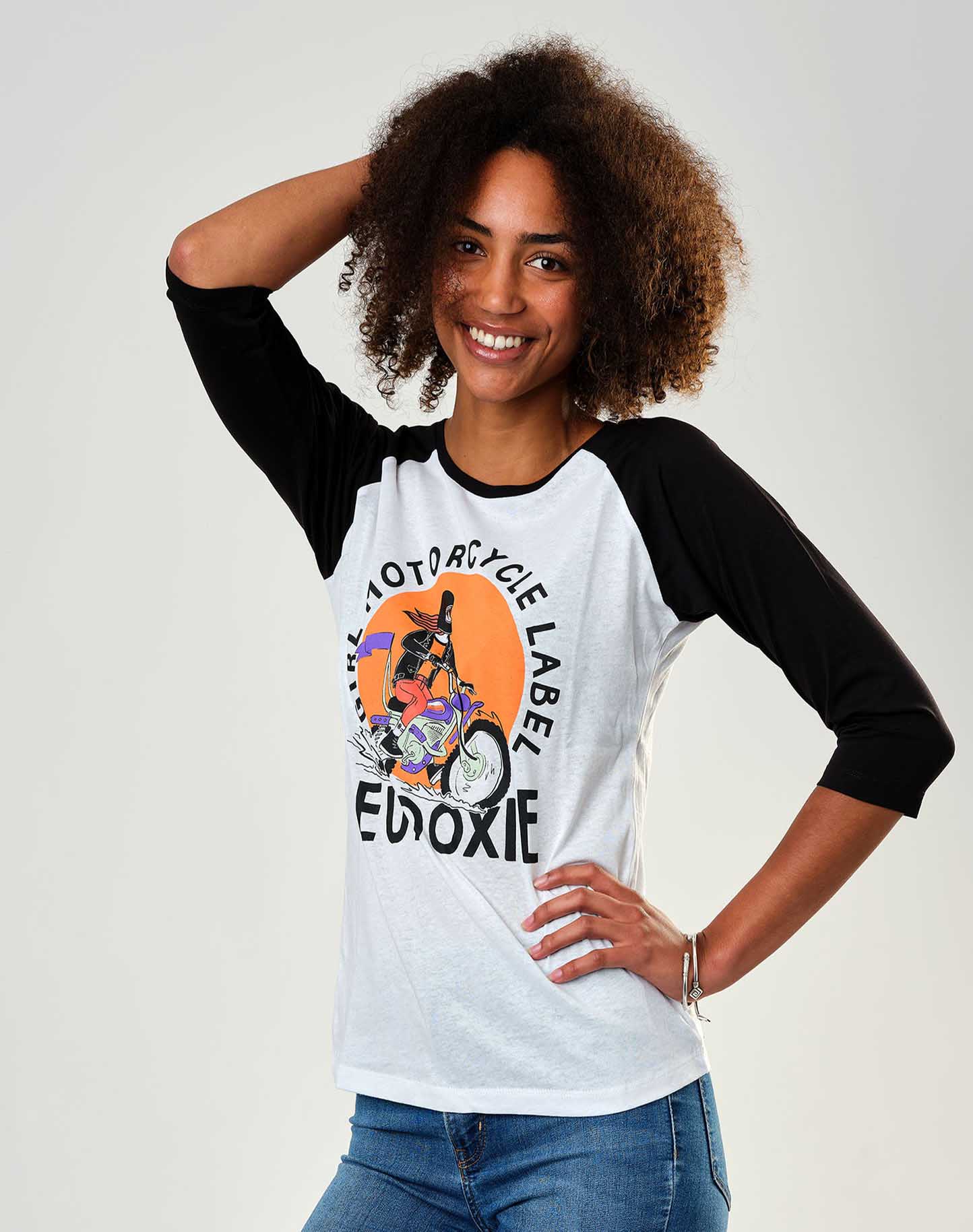 A young woman wearing black &amp; white baseball motorcycle t-shirt from Eudoxie 