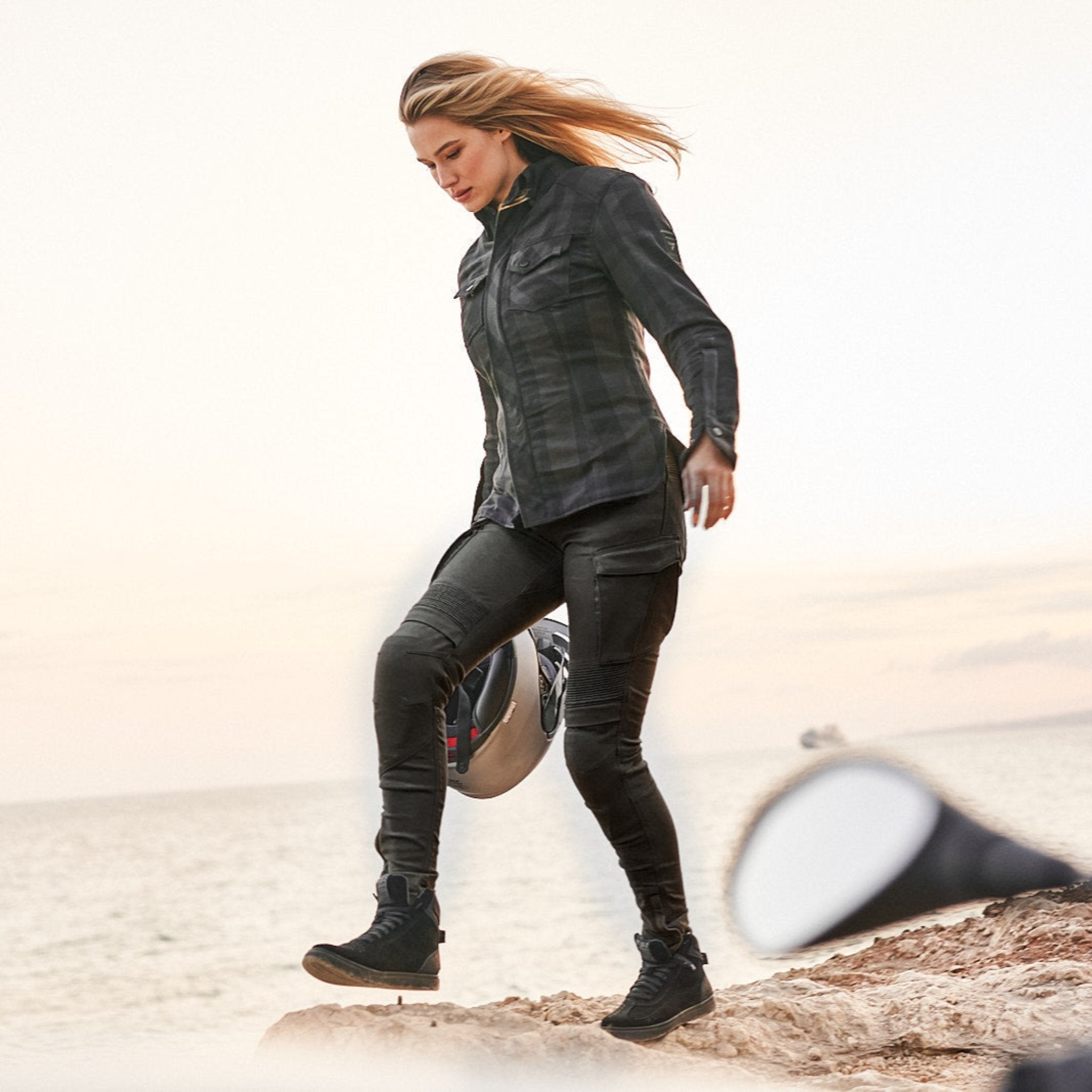 a woman on a beach wearing Khaki green women&#39;s motorcycle cargo pants GIRO from shima