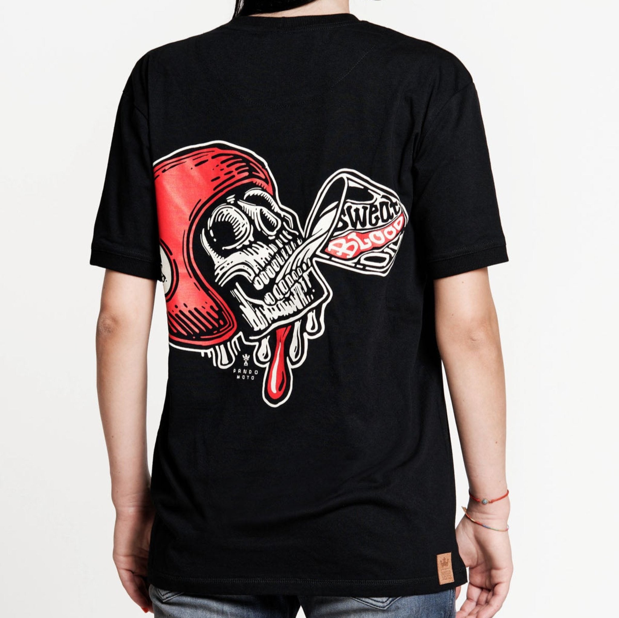 A woman wearing black Pando Moto women's motorcycle t-shirt with red scull motive